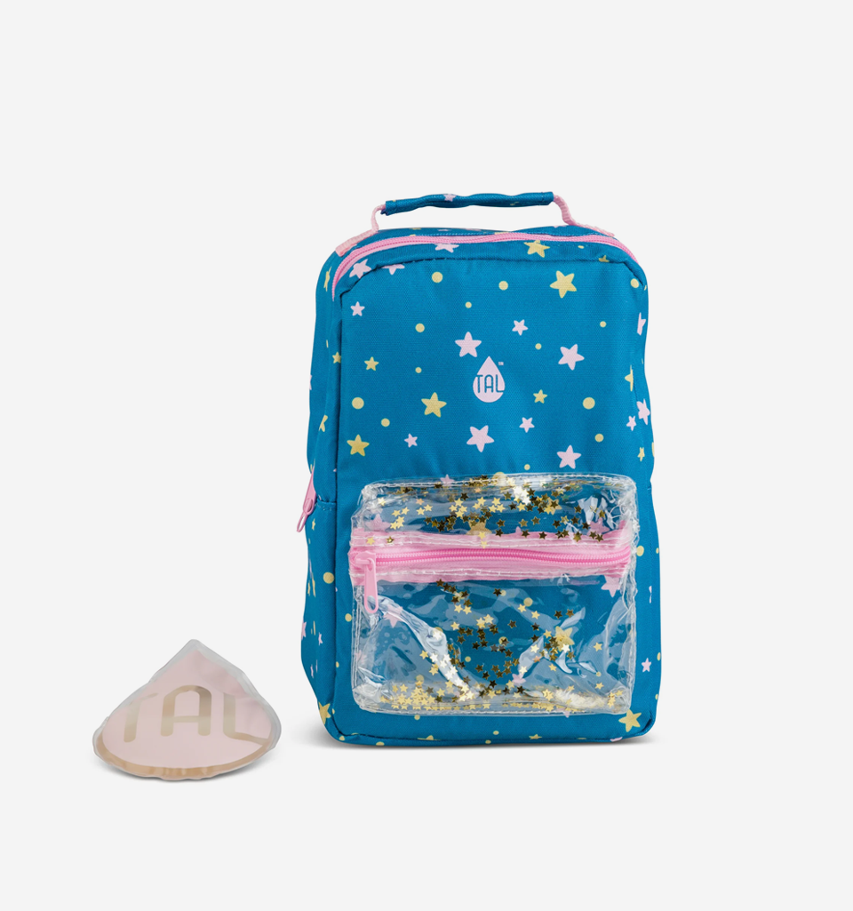 A blue insulated lunch bag with a star pattern, featuring pink straps, a front pocket with a clear window, and accompanied by a reusable ice pack.
